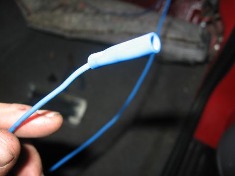 2000 Ford Ranger - A close-up shot shows a person holding a blue wire with a white connector, likely for an electrical repair.