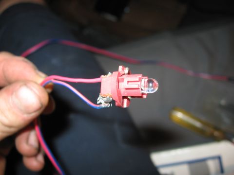 2000 Ford Ranger - Close-up of a red plastic electrical connector with a clear LED bulb and attached wires, likely for an aftermarket alarm system.