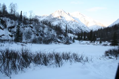 2003 Jeep TJ - Winter scene in a mountain valley with snow-covered slopes and trees.