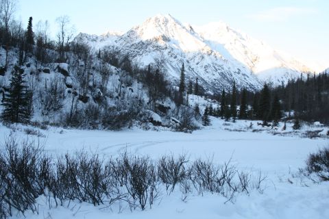 2003 Jeep TJ - A vast winter landscape unfolds with snow-covered mountains and a frozen expanse in the foreground.