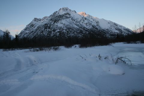 2003 Jeep TJ - A vast winter scene unfolds with snow-covered mountains dominating the horizon.