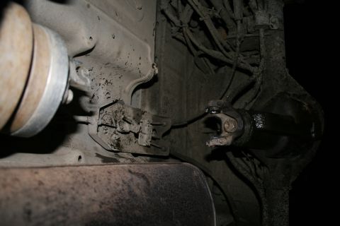 2003 Jeep TJ - Close-up of the vehicle's undercarriage, showing the driveshaft and differential assembly.