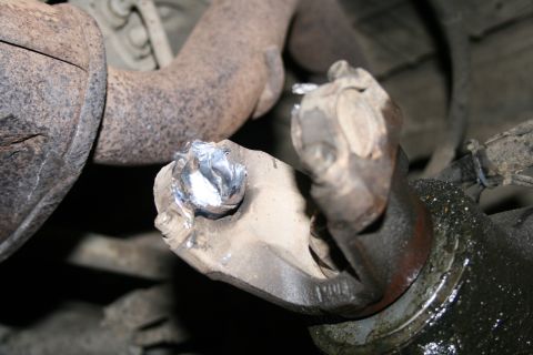 2003 Jeep TJ - Close-up of a damaged driveshaft universal joint, indicating potential mechanical issues.
