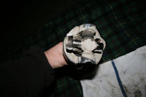 2003 Jeep TJ - A close-up shows a broken universal joint, likely from a vehicle's drivetrain.