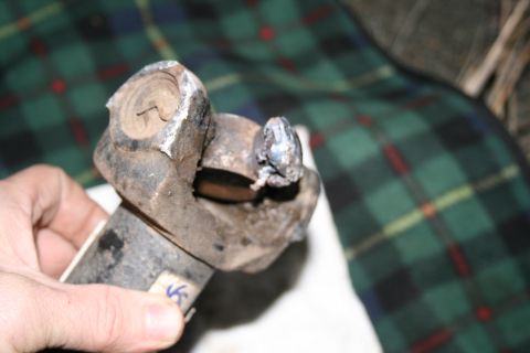 2003 Jeep TJ - Close-up of a damaged driveshaft U-joint, indicating wear and potential failure.