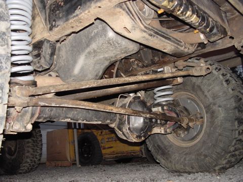 1979 Ford Bronco - Undercarriage detail of a vehicle, focusing on suspension and drivetrain components.