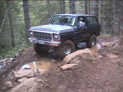 1979 Ford Bronco - Ford Bronco tackles a challenging off-road course through a wooded area.