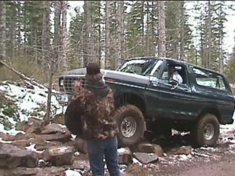 1979 Ford Bronco - This 1979 Ford Bronco navigates a challenging rocky path in a wooded area.