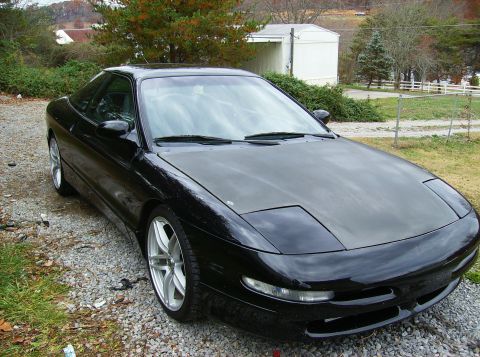 1995 Ford Probe - Black 1995 Ford Probe GT coupe with pop-up headlights and aftermarket wheels.