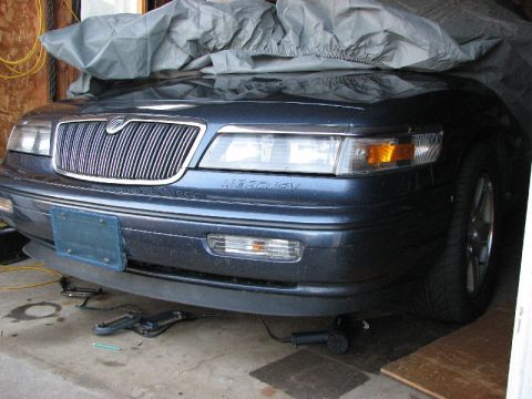1985 Mercury Grand Marquis - The front end of a Mercury Grand Marquis is shown, with a car cover draped over the hood and roof.