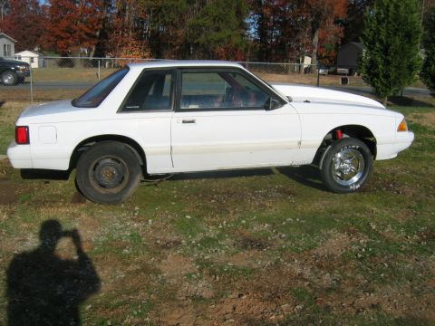 1992 Ford Mustang - Side view of a white 1992 Ford Mustang coupe modified with a cowl hood and drag wheels.