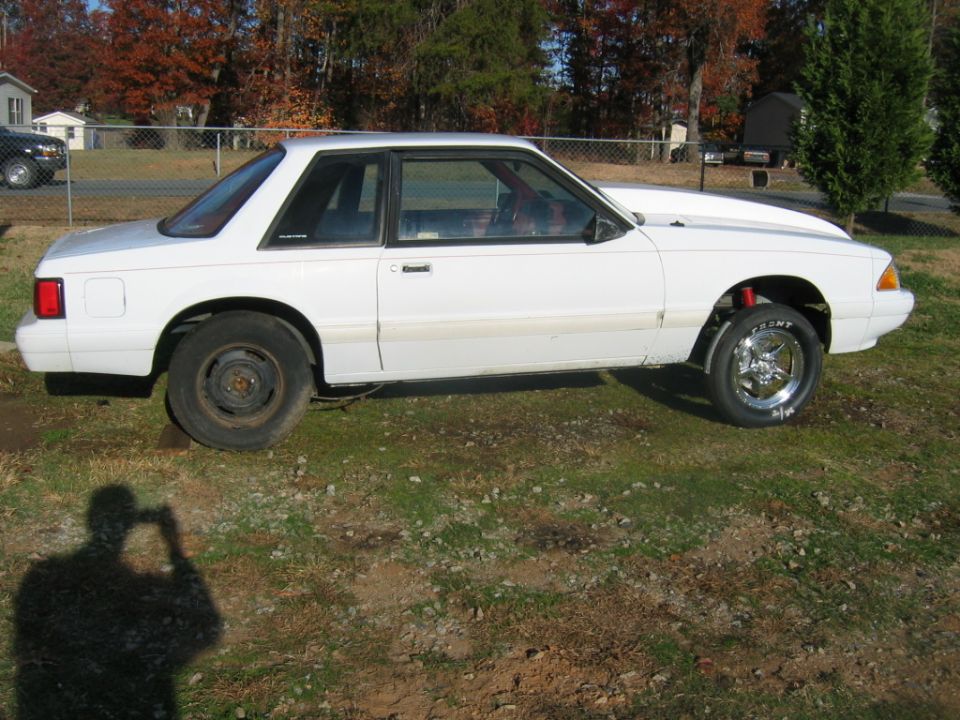 White 1992 Ford Mustang coupe with a cowl induction hood, lowered stance, and different wheels front to back
