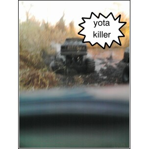 1995 Dodge 1500 - An off-road vehicle navigates a muddy terrain, with a humorous 'yota killer' label superimposed.