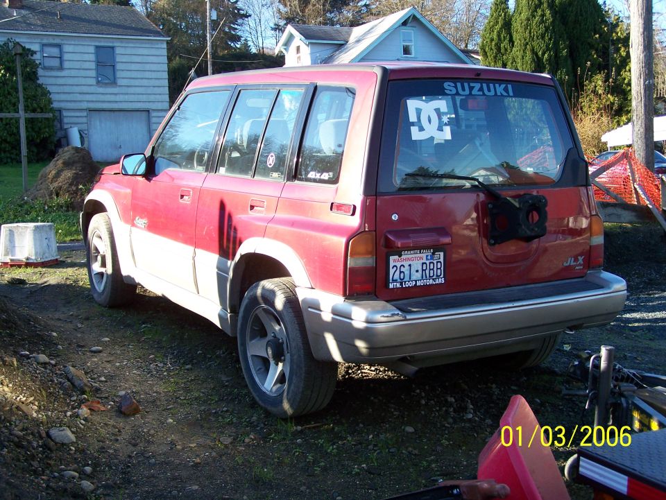 Red and white SUV rear view with DC Shoes logo and SUZUKI decal