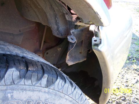 1988 Suzuki Samurai - The fender and surrounding components appear damaged, with the tire visible in the foreground.