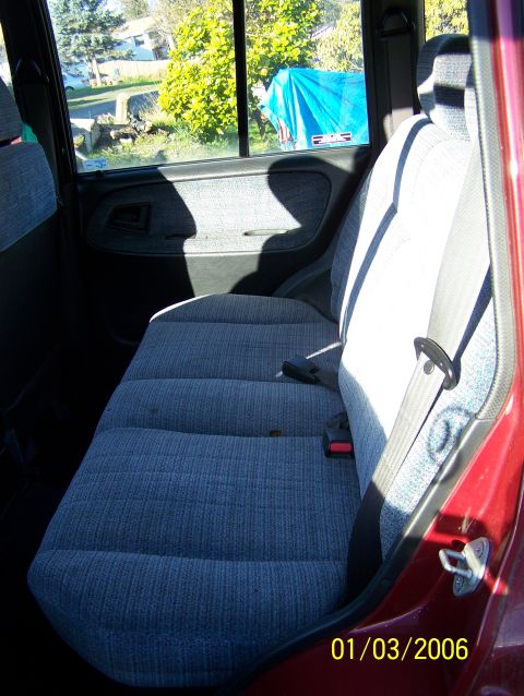 1988 Suzuki Samurai - The interior of a red SUV shows the rear seat and door panel. The date stamp indicates the photo was taken on January 3, 2006.