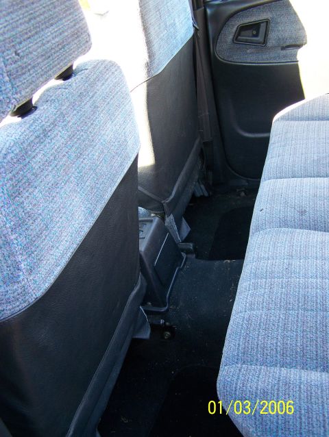 1988 Suzuki Samurai - Rear interior view of a vehicle, showing the seats and door panel. Watermark indicates date and website.