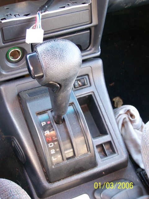 1988 Suzuki Samurai - Close-up of the automatic transmission shifter and center console area of a vehicle.