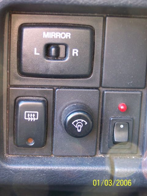 1988 Suzuki Samurai - Interior dashboard controls include a mirror selector, rear defroster switch, and dimmer knob.