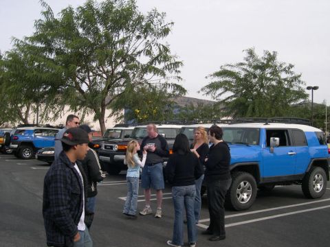 2007 Toyota FJ Cruiser - A group of Toyota FJ Cruisers are parked in a lot, with several people gathered around.