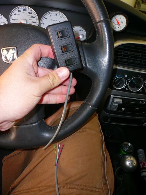 1996 Ford Probe - A hand holds a switch panel inside a Dodge SRT-4, with visible gauges and interior details.