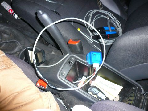 1996 Ford Probe - Interior view of a car's center console, highlighting the handbrake and various electronic accessories.