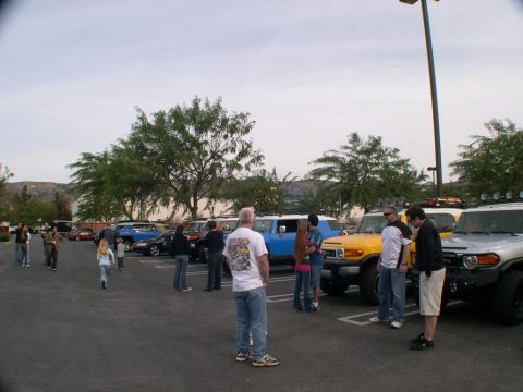 2007 Toyota FJ Cruiser - Several Toyota FJ Cruisers, including a yellow one, are gathered in a parking lot.
