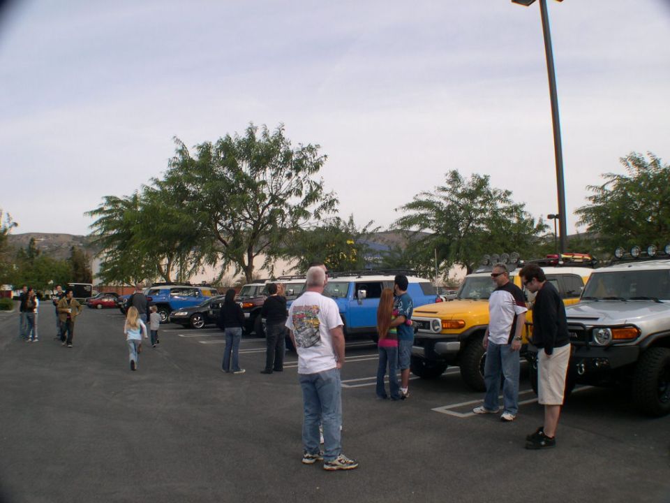 Yellow 2007 Toyota FJ Cruiser parked in lot with other FJs