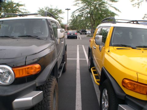 2007 Toyota FJ Cruiser - Two Toyota FJ Cruisers are parked next to each other in a parking lot.