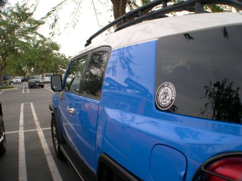 2007 Toyota FJ Cruiser - A blue 2007 Toyota FJ Cruiser is parked in a lot, showing its side and rear quarter panel.