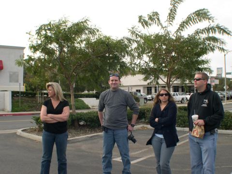 2007 Toyota FJ Cruiser - A group of four people stand in a parking lot, with trees and buildings visible in the background.
