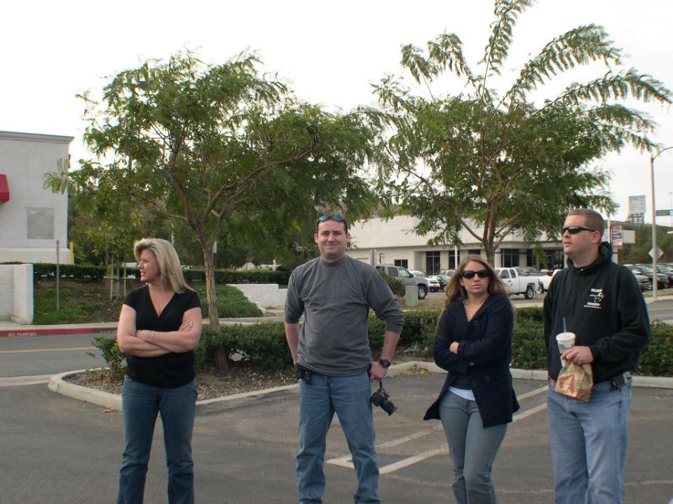 Four people stand in a parking lot