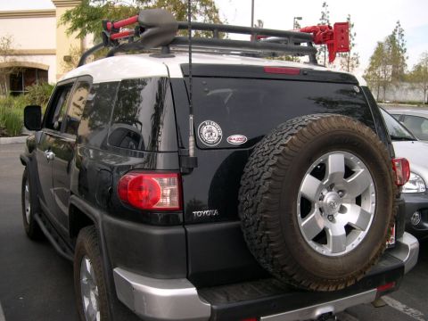 2007 Toyota FJ Cruiser - A black 2007 Toyota FJ Cruiser is viewed from the rear, equipped with a spare tire and a roof rack.