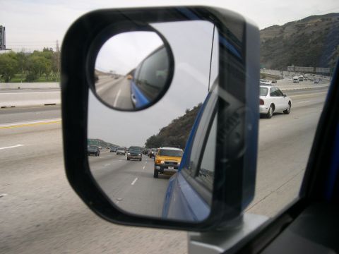 2007 Toyota FJ Cruiser - View of highway traffic from a vehicle's side mirror, showing multiple cars.