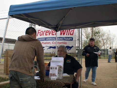 2007 Toyota FJ Cruiser - Event attendees interact under a canopy, with a banner for an exotic animal sanctuary visible.