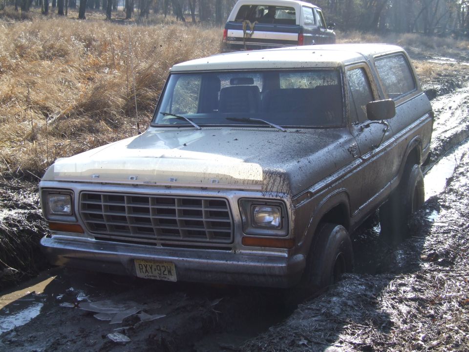 Ford Bronco stuck in mud with another Bronco behind it