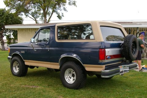 1986 Ford Bronco - This Ford Bronco features a two-tone paint scheme with a blue body and tan accents.