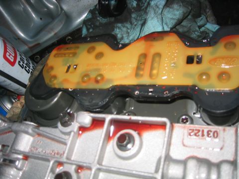 1973 Ford F-100 - Close-up of a transmission valve body, showing the circuit board and fluid.