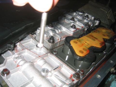 1973 Ford F-100 - Close-up of a transmission valve body during repair work.