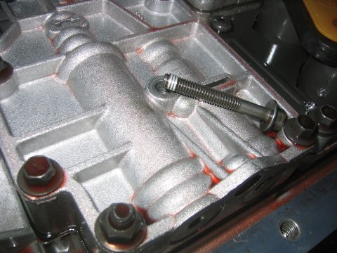 1973 Ford F-100 - Close-up view of the inside of a transmission pan, showing internal components and fluid residue.
