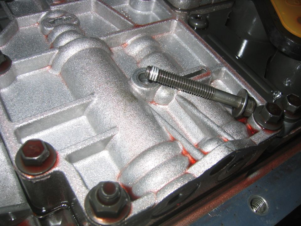 Automatic transmission valve body in aluminum case with red sealant and bolts