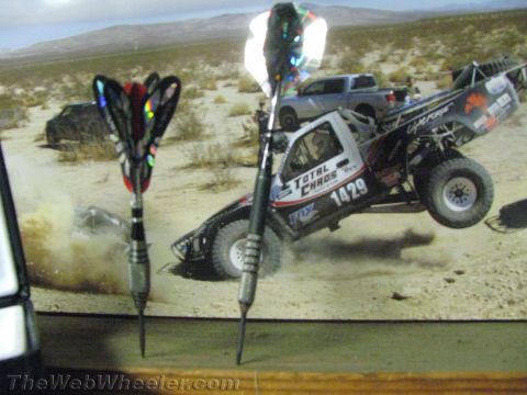 1968 Ford Mustang - Photo of a desert racing truck in mid-air, with two darts in the foreground.