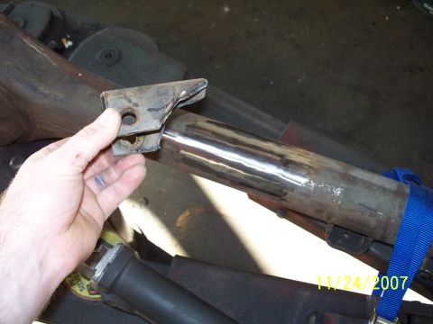 2007 Ford Ranger - Close-up of a hand holding a metal bracket near a vehicle's exhaust pipe, with a date stamp visible.