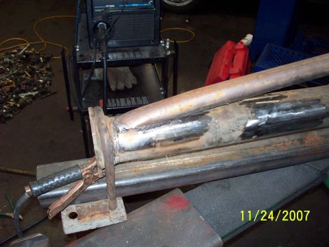 2007 Ford Ranger - A close-up view of exhaust pipe being welded, with a welding machine and a date stamp visible in the background.