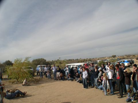 2007 Toyota FJ Cruiser - A group of people and vehicles are gathered in a desert landscape, with a 2007 Toyota FJ Cruiser visible.