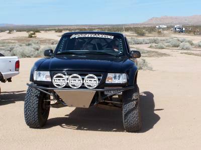 2007 Ford Ranger - A modified 2007 Ford Ranger is parked in a desert landscape with other vehicles in the background.