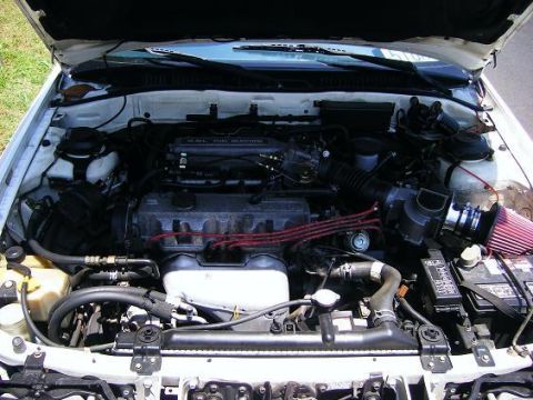 1991 Mazda MX-6 - The engine compartment of a car is shown with various components and wiring visible.