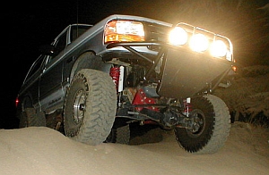 1986 Ford Bronco - Modified 1986 Ford Bronco equipped with off-road lights and suspension, seen at night.