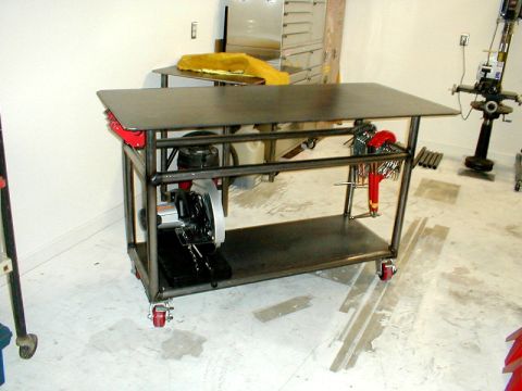 1996 Ford Bronco - A metal fabrication cart holds a chop saw, wrenches, and other tools.