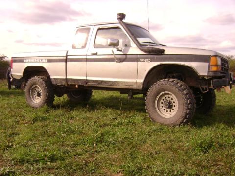 1990 Ford Ranger - This 1990 Ford Ranger pickup truck features a snorkel and off-road tires, suggesting it's equipped for terrain.